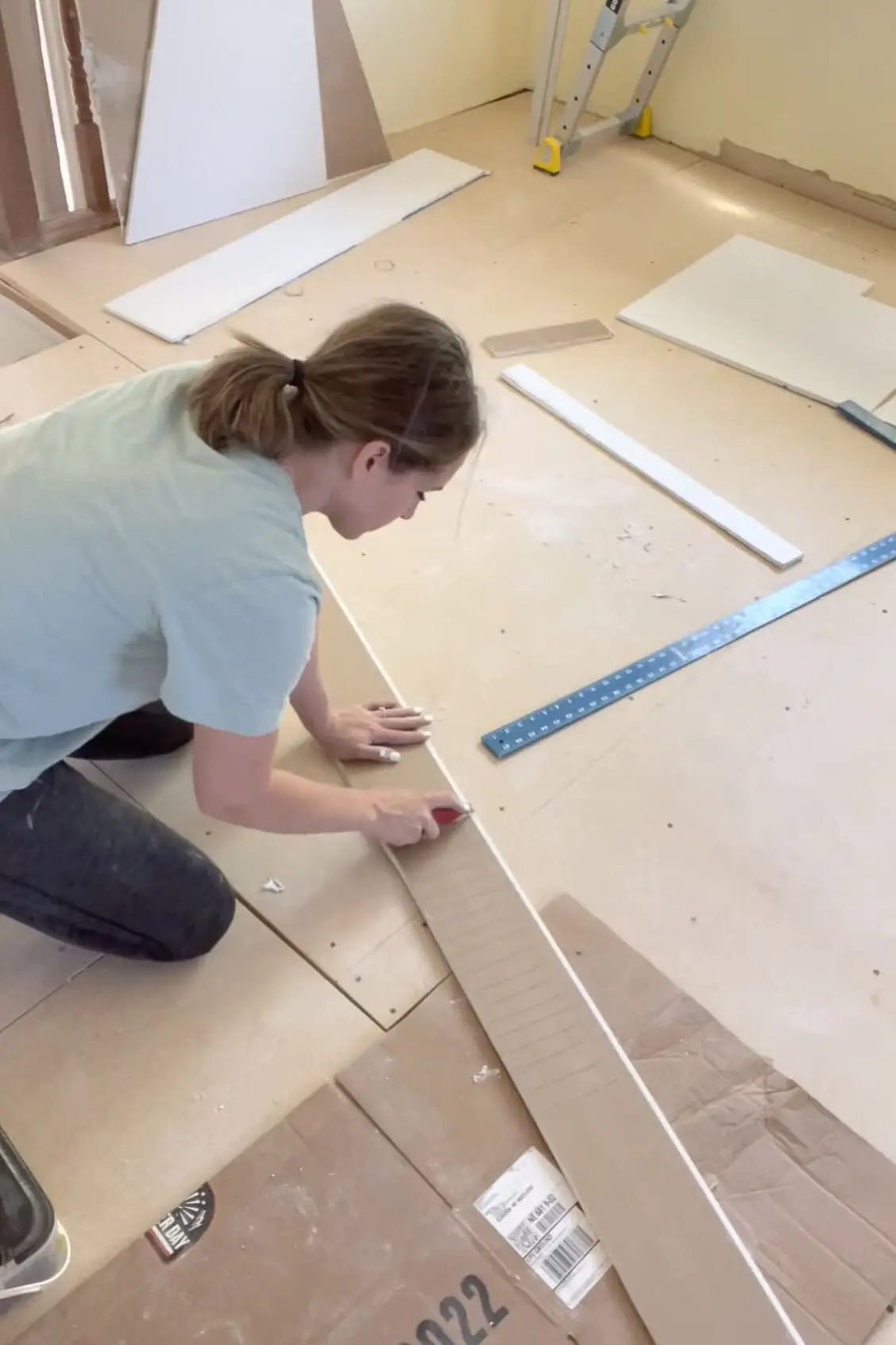 Scoring drywall to bend it to fit in an arched doorway.